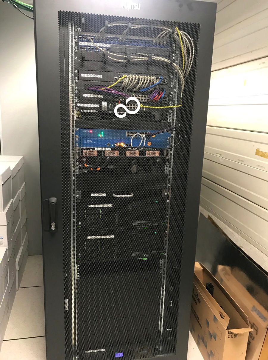 42U server rack in a technical room, patching and telephony integrated